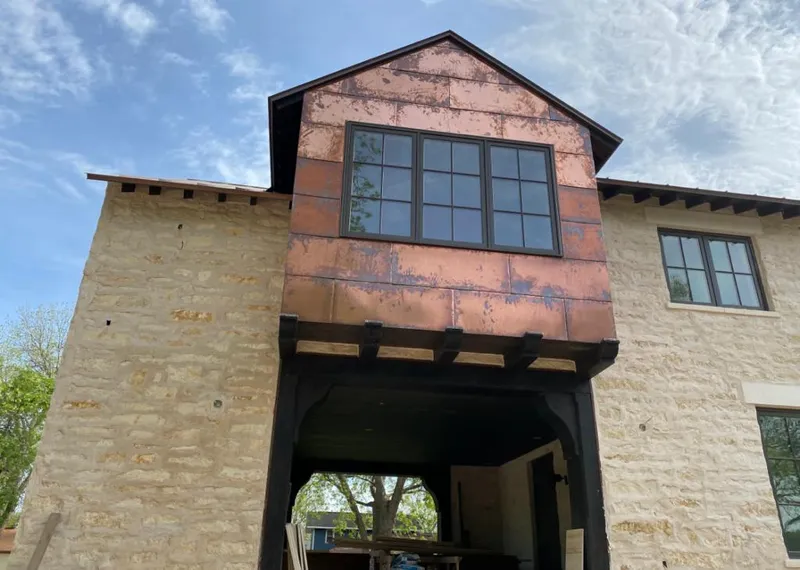 Copper metal panel facade on a stone building for Metal Roof Coating in Horace